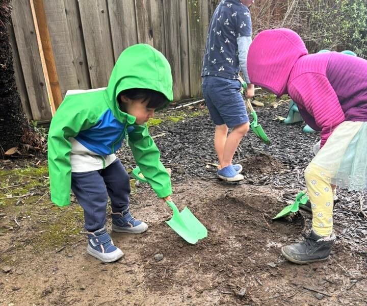 Parent and toddler walking barefoot in nature, practicing calm and connection